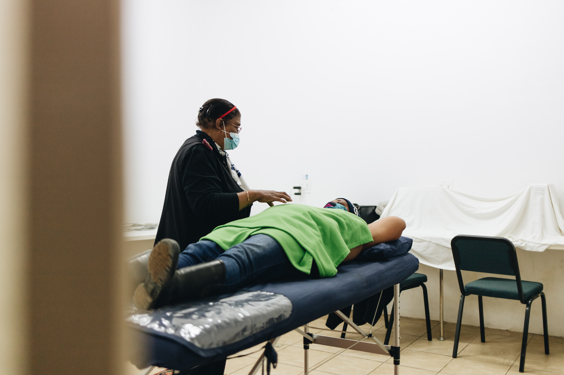 Nurse performing a free breast health screening